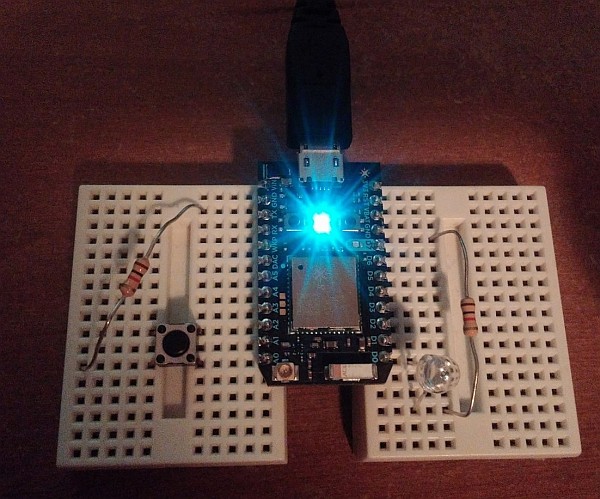 Photon connected to breadboard with a button attached.